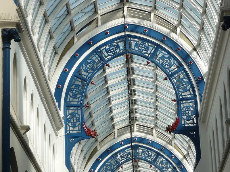 Looking up at the blue ironwork and glass roof of Thornton's Arcade