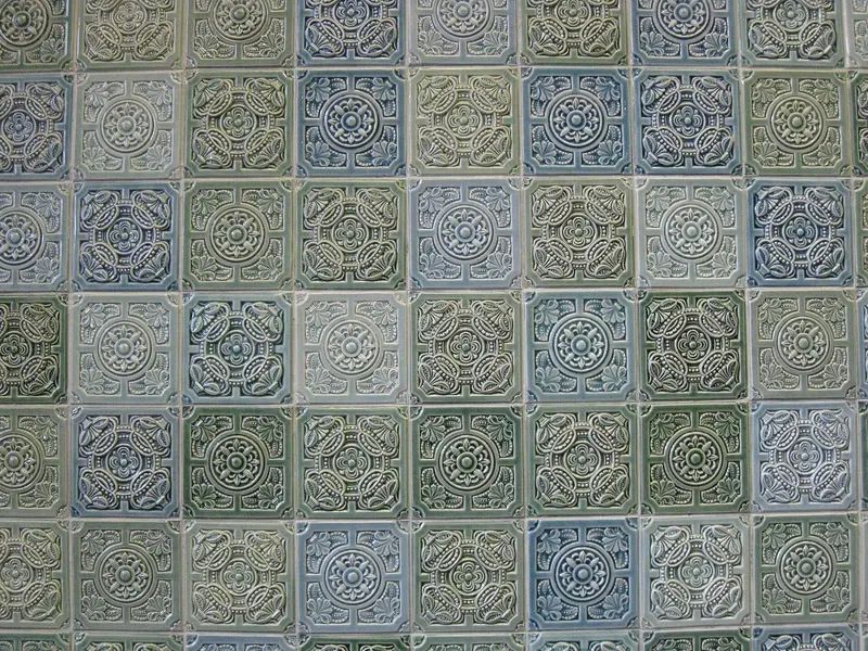 Glazed green and blue relief tiles on a wall of the Tiled Hall